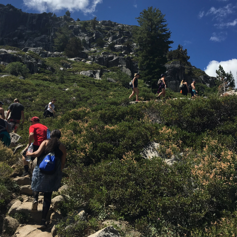 A group hikers walking up a mountain trail.