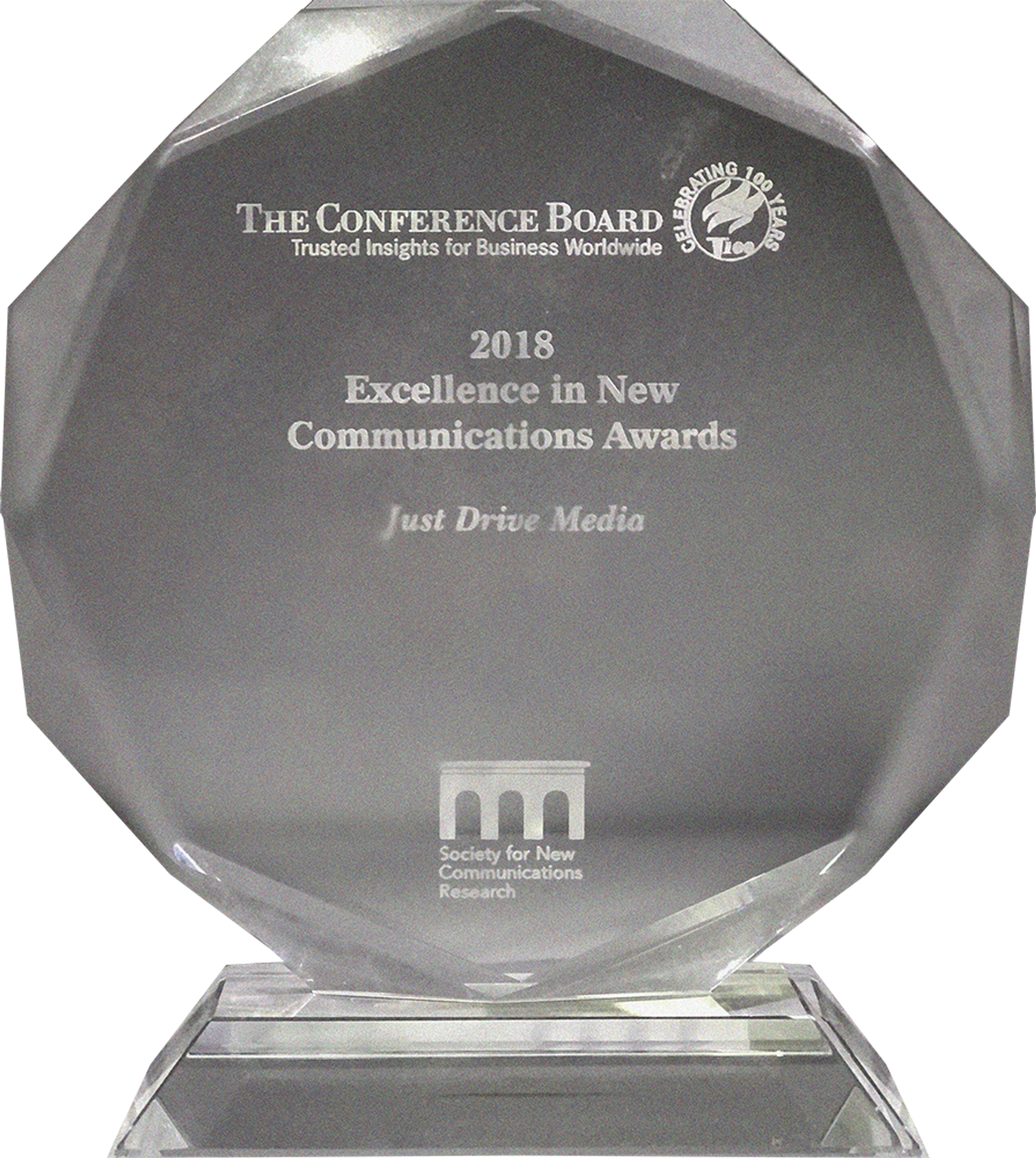 A glass award for "Excellence in New Communications" from 2018 by The Conference Board for Just Drive Media.