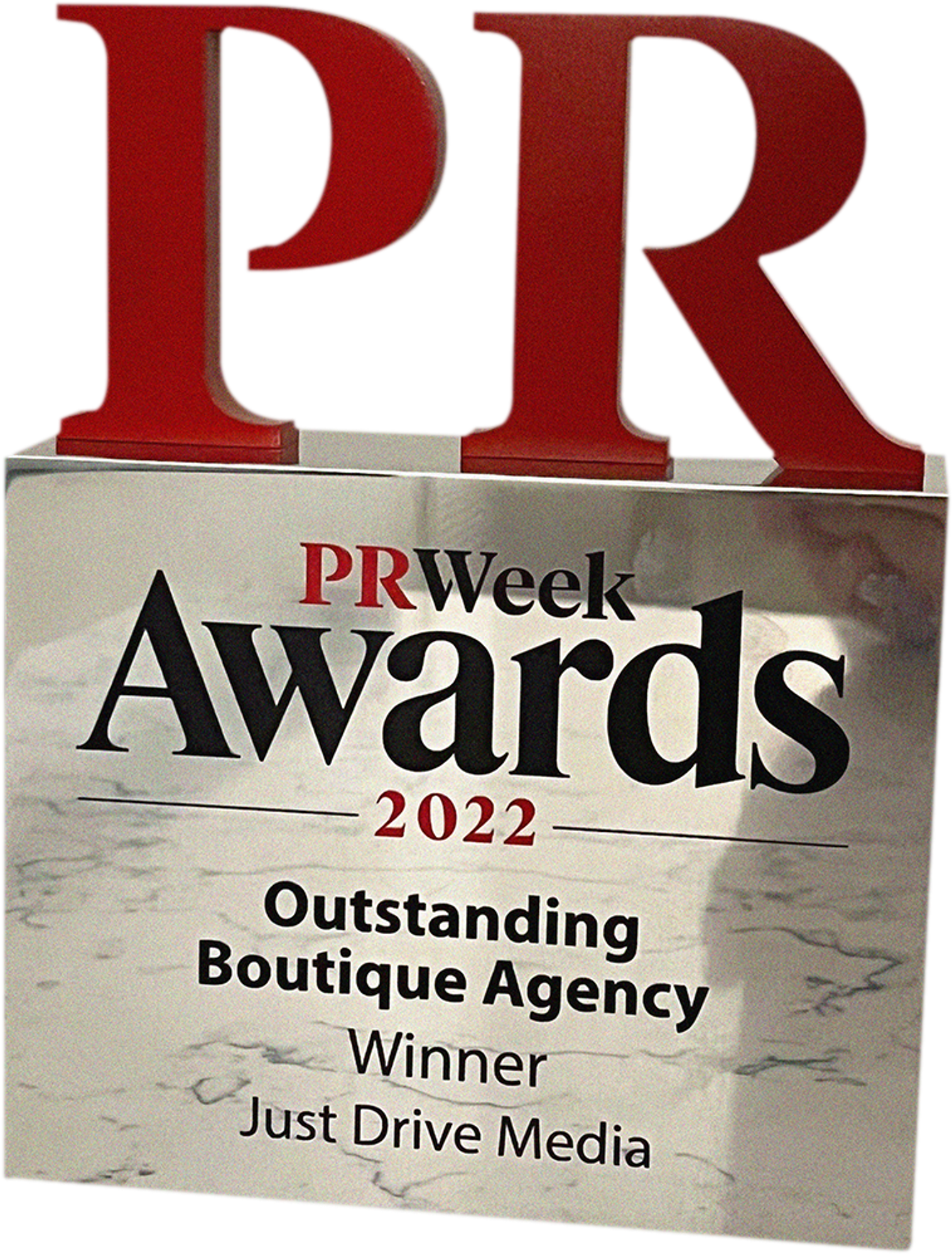 An award trophy for "PRWeek Awards 2022" recognizing the "Outstanding Boutique Agency," won by "Just Drive Media."